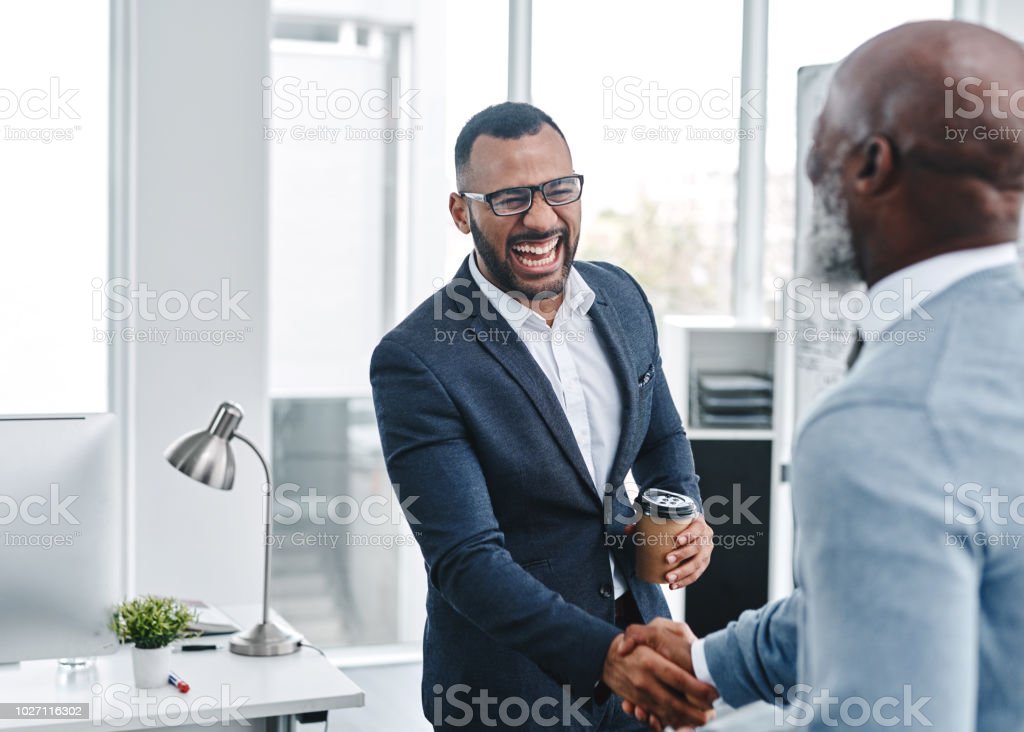 Shot of two businessmen shaking hands in an office